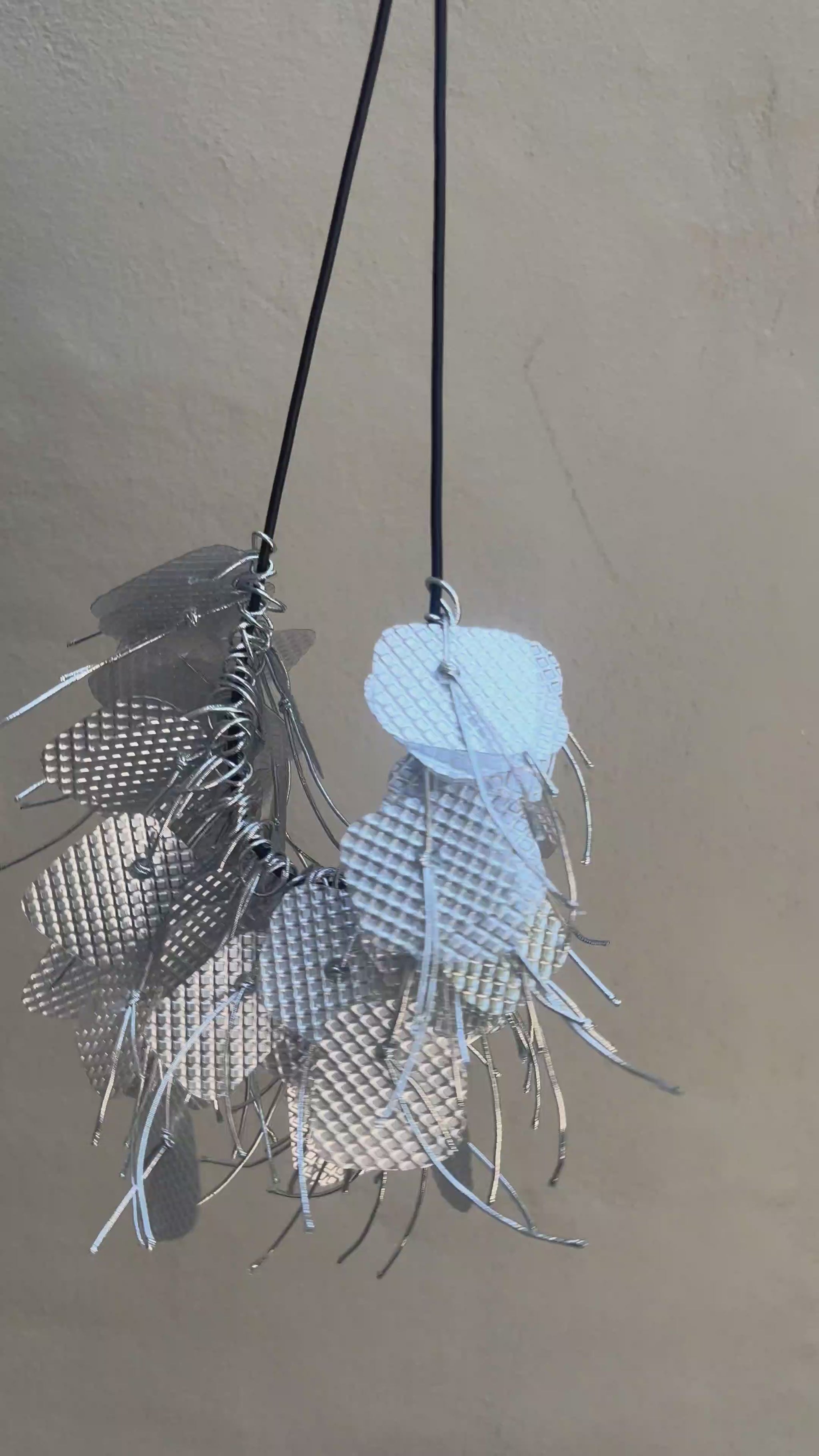 A silver necklace spins around