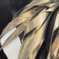 A mannequin wears a gold painted rubber necklace